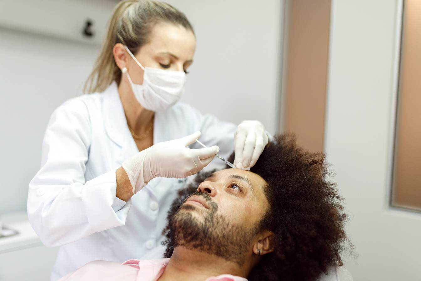 Man getting botox applied to his forehead